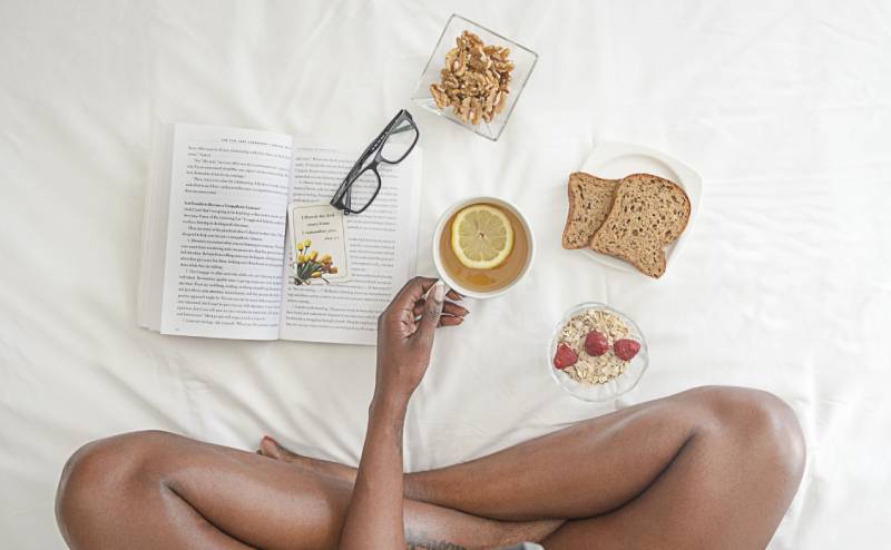 Woman reading a book with good morning quotes