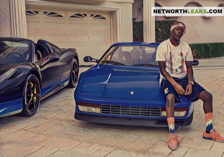 Lil Yachty standing next to his two Ferrari's