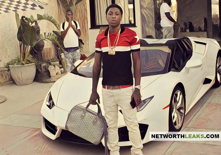 NBA YoungBoy standing next to his Lamborghini